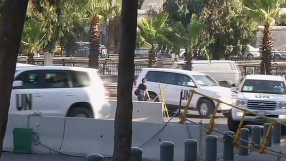 Cars carrying UN inspectors return to their hotel in Damascus