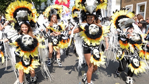Carnival performers don skull costumes in Notting Hill