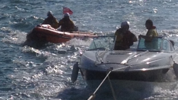 Boat being towed by lifeboat