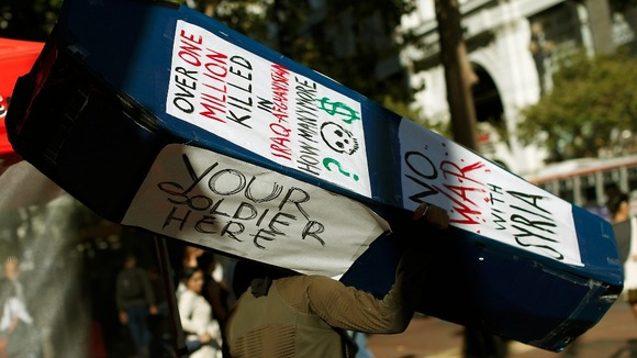 A demonstrator holds a coffin-shaped box during a rally in San Francisco.