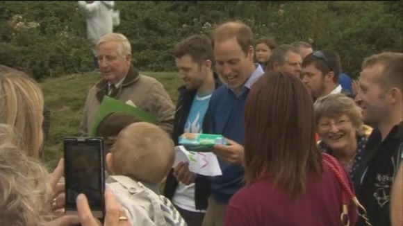 Prince William is given a present t help him with changing Prince George's nappies.