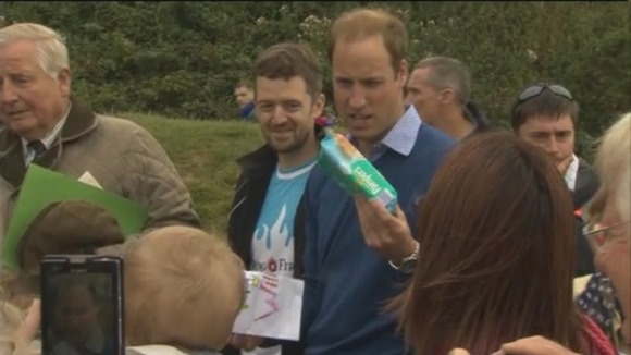 Prince William is given a present t help him with changing Prince George's nappies.