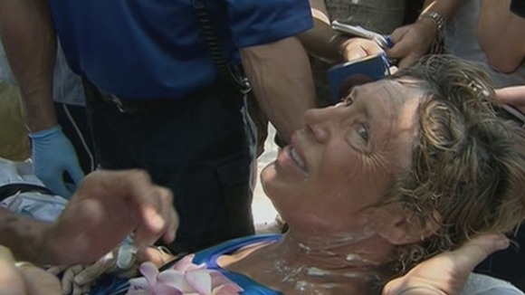 Diana Nyad tries to smile for the cameras after her epic 110-mile swim from Cuba to Florida.
