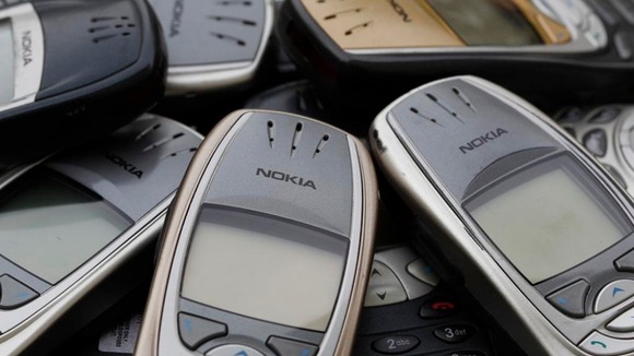Old Nokia phones piled up.
