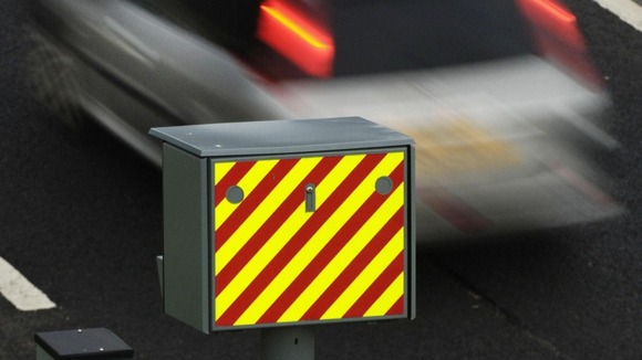 Car passing a speed camera.