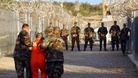 US Army military police escort a detainee in Guantanamo Bay in 2002.