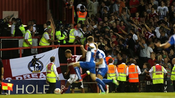 Bristol City's fans on the right are kept away from Bristol Rovers fans by stewards
