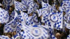 Chelsea fans waving flags.