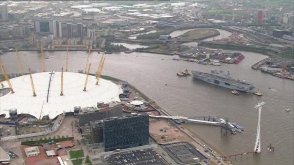 HMS Ocean passes the O2 arena.