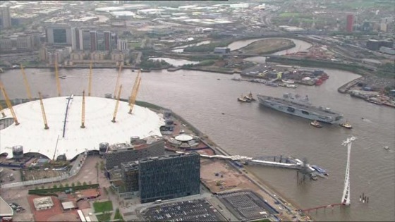 HMS Ocean passes the O2 arena.