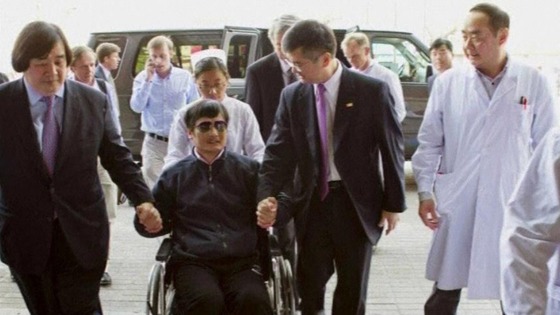 Chen Guangcheng in a wheelchair arriving at a Beijing hospital on Wednesday