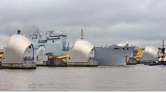HMS Ocean passes through the Thames Barrier.