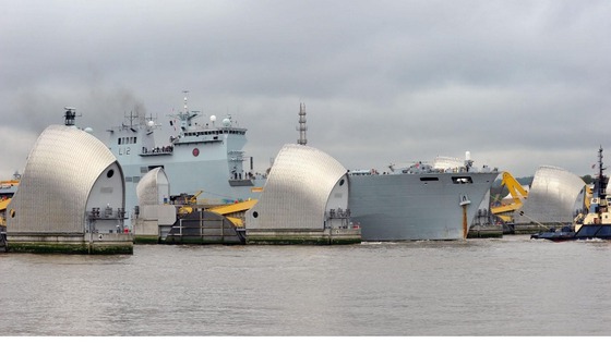 HMS Ocean passes through the Thames Barrier.