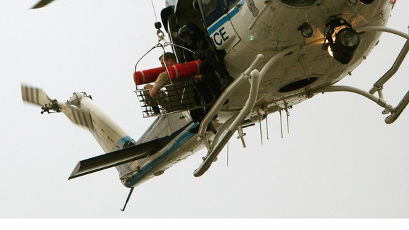 An apparent victim is carried from the scene by police helicopter