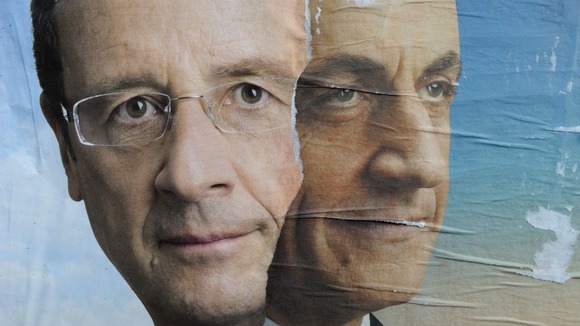 Official campaign posters for Nicolas Sarkozy (R) and Francois Hollande.