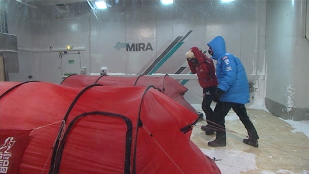 Two members of the team battle the wind in the chamber.