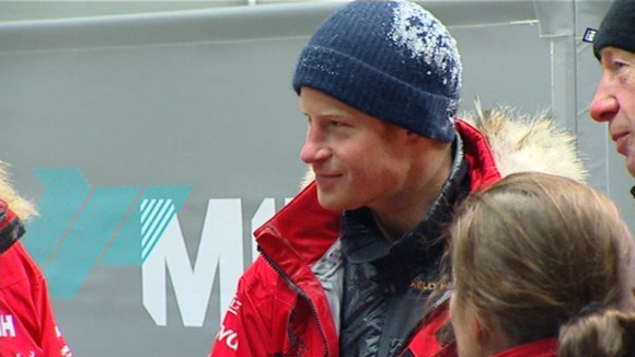 Still covered in ice Prince Harry warms up after the freezing temperatures inside the cold chamber.