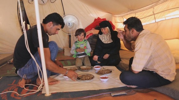 Um Shadi Bardan and her family in their tent