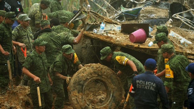 Soldiers and police work around the wreckage of a bus after it was buried by a mountain landslide at Altotonga, Veracruz state