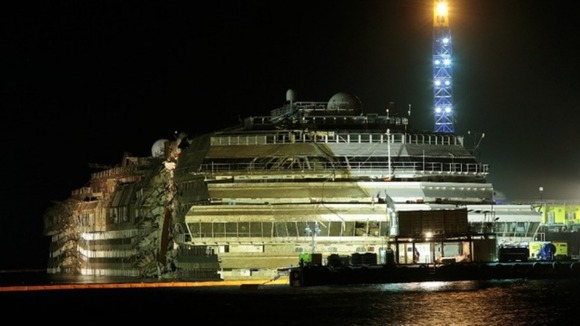 The previously capsized cruise liner Costa Concordia is seen at the end of the "parbuckling" operation outside Giglio harbour this morning.