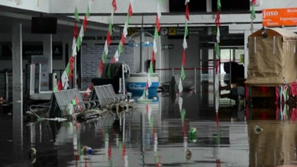 The airport buildings are flooded stranding tourists.