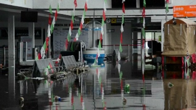 The airport buildings are flooded stranding tourists.