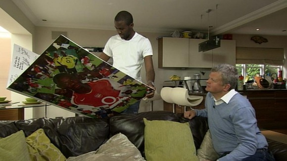 Fabrice Muamba shows Adrian Chiles the card his former Arsenal team-mates made him.