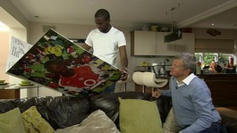 Fabrice Muamba shows Adrian Chiles the card his former Arsenal team-mates made him. 
