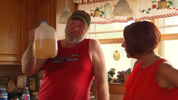 Man holding bottle of dirty water