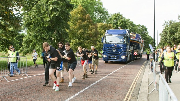 A team pulls a huge lifeboat through Hyde Park.