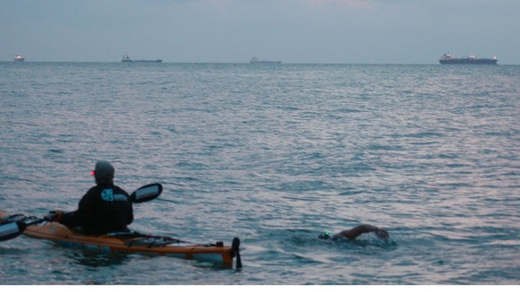Anna Wardley with a support boat during her round the island swim