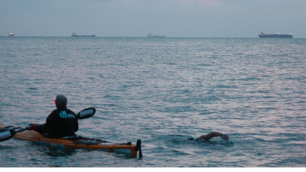 Anna Wardley with a support boat during her round the island swim