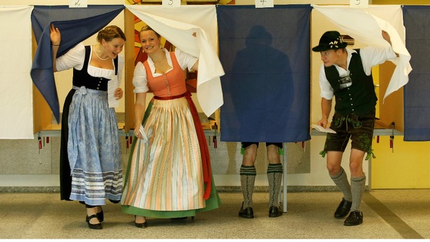 Voters Veronika Stuerzer, Monika Merk, Johann Merk and Michael Merk (L-R) wearing traditional Bavarian costume cast their ballots