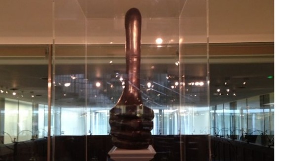 A 10 metre tall thumbs-up, cast in a dark patina