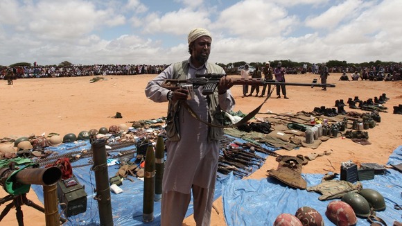 An al-Shabaab fighter displays his loot of weapons recovered from peacekeepers, in Somalia in 2011.