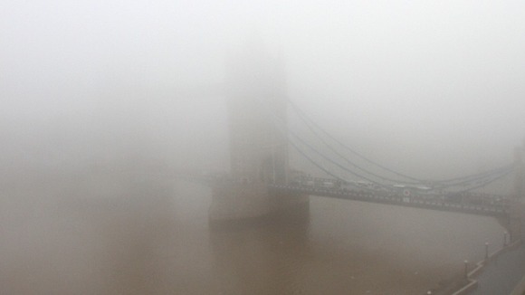 A view of Tower Bridge in fog in central London this morning.