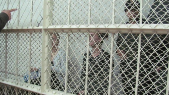 Melissa Reid and Michaela McCollum Connelly behind bars inside the court in Peru.