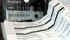 An energy bill next to an electricity meter.