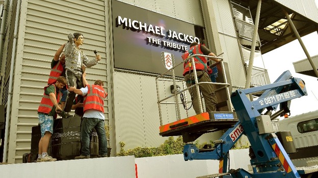 A group of stonemasons take down the statue of Michael Jackson