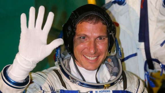 nternational Space Station crew member US astronaut Michael Hopkins waves as he boards the Soyuz TMA-10M spacecraft.