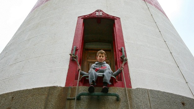 Boy on lighthouse steps