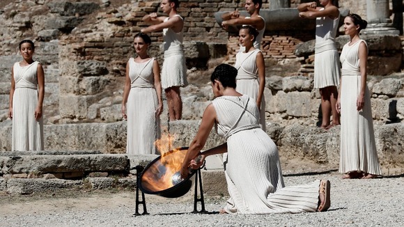 The torch is lit using the sun's rays reflected in a parabolic mirror.