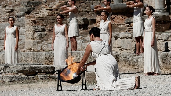 The torch is lit using the sun's rays reflected in a parabolic mirror.