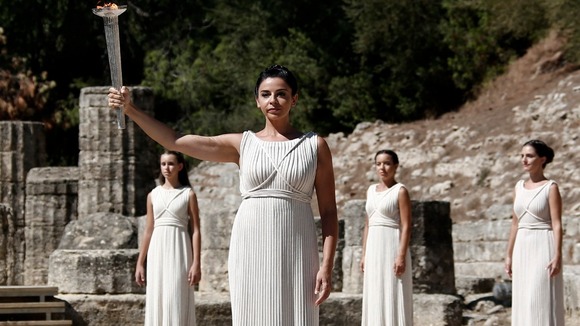 The Olympic flame is raised at the site of Ancient Olympia in Greece.