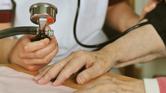 A women has her blood pressure checked.