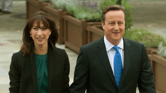 Prime Minister David Cameron arrives with his wife Samantha before giving his keynote speech