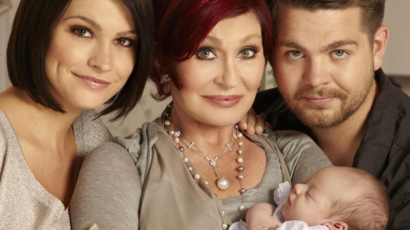 Sharon Osbourne holding her new grandchild Pearl, with proud parents, Jack Osbourne and fiancee Lisa Stelly