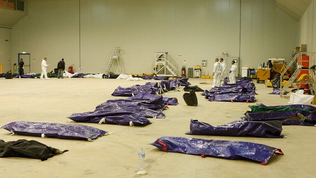 Body bags containing African migrants, who drowned trying to reach Italian shores, lie in a hangar of the Lampedusa airport