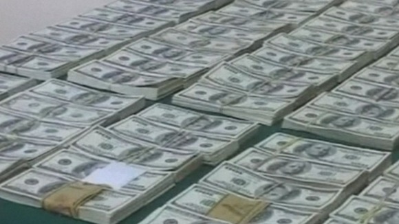 Some of the wads of US bank notes thrown from the plane