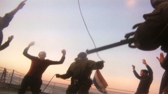 Photo purportedly showing Russian officials holding Greenpeace activists at gunpoint